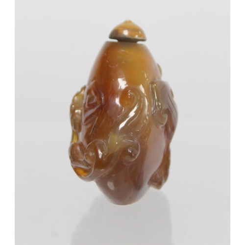 361 - 20th century Chinese dark yellow agate snuff bottle of pear form carved with Chilong with similarly ... 