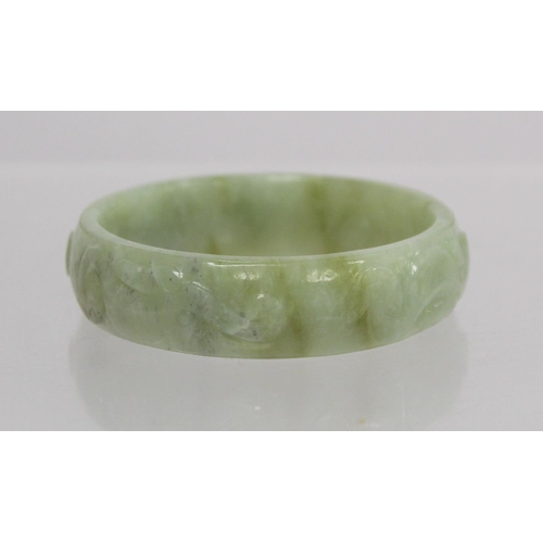 368 - Chinese pale green mottled jade bangle with relief carved decoration of Chilong, approx. 7.5cm diam.... 