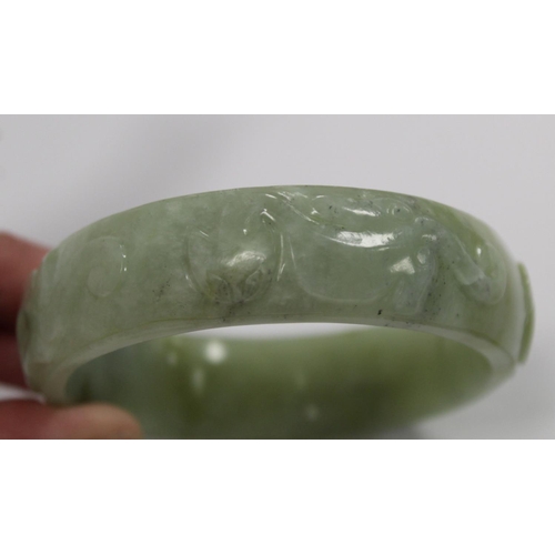 368 - Chinese pale green mottled jade bangle with relief carved decoration of Chilong, approx. 7.5cm diam.... 