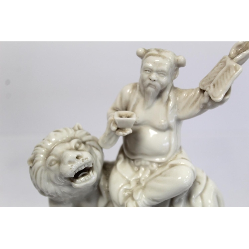 376 - Chinese blanc de chine porcelain figure of the lion Spirit King (Shituowang) sitting on a lion holdi... 