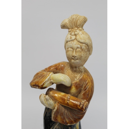 379 - Chinese Sancai glazed figure of a Tang dynasty female musician holding a guqin, the head and ne... 