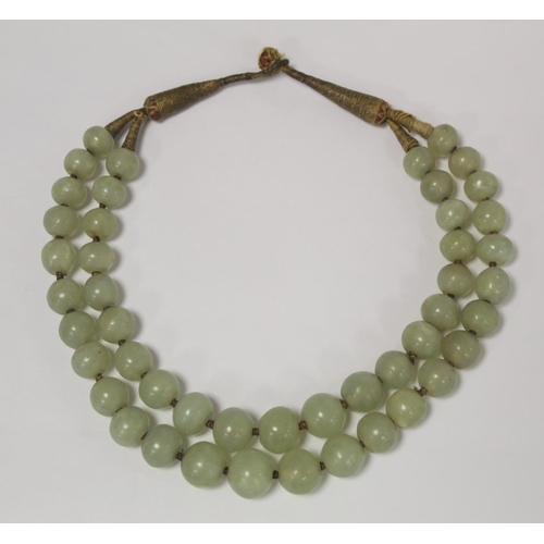 381 - Antique Oriental double strand of jade beads, probably Chinese, with loop and button fastening in me... 