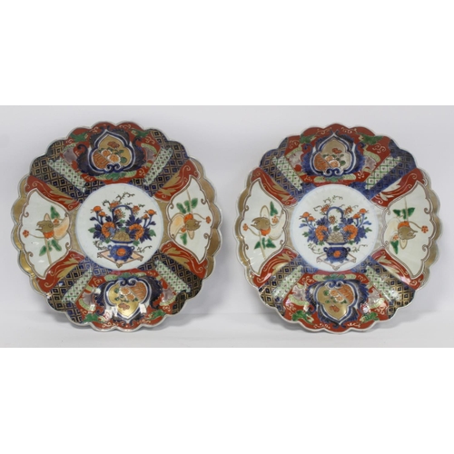 384 - Pair of Japanese Imari chargers of circular lobed form with central panels of vases of flowers and f... 