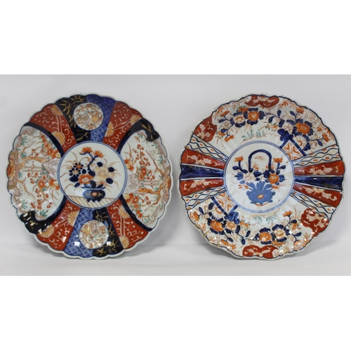 386 - Two Japanese Meiji period Imari chargers of lobed circular form, the central circular panels of vase... 