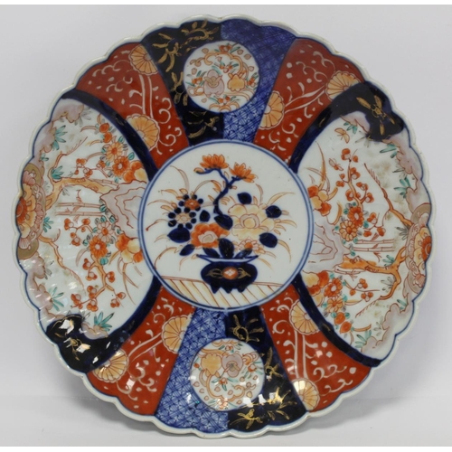 386 - Two Japanese Meiji period Imari chargers of lobed circular form, the central circular panels of vase... 