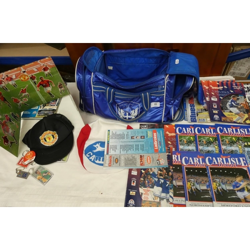 28 - Carlisle United and Manchester United programmes, flag, bag, keyrings, etc.