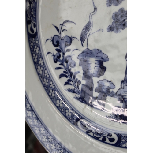 322 - 18th century Chinese export blue and white circular charger, the central panel depicting cranes in a... 