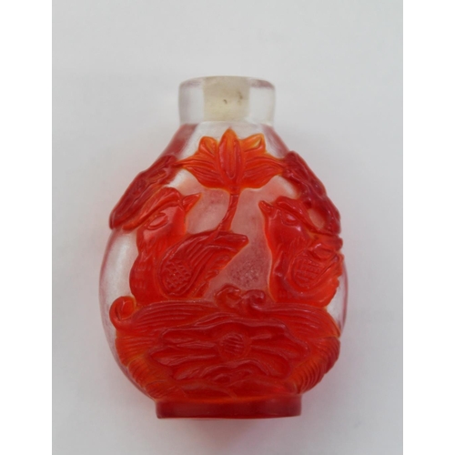 349 - Chinese 19th century snuff bottle with red overlay on snow ground, carved with mandarin ducks and lo... 