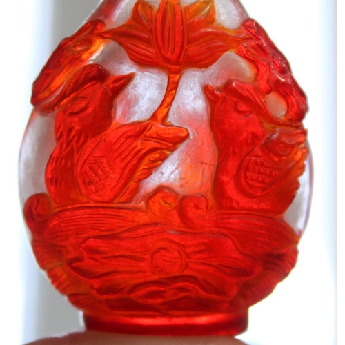 349 - Chinese 19th century snuff bottle with red overlay on snow ground, carved with mandarin ducks and lo... 