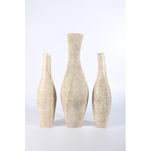 89 - JEAN JENKINS, a set of three twisted stoneware bottle vases, the largest 36cm tall.