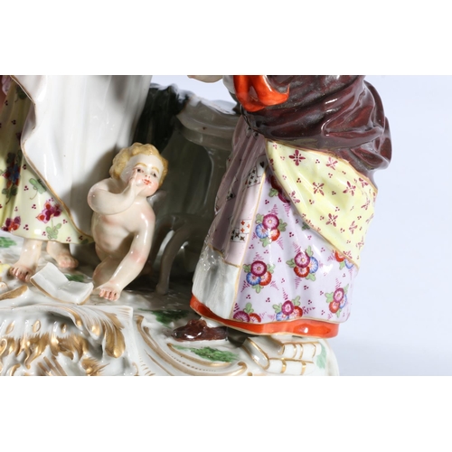 1 - Antique German porcelain figure group modelled as a fortune teller palm reading a lady with a cherub... 