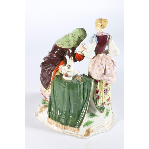 1 - Antique German porcelain figure group modelled as a fortune teller palm reading a lady with a cherub... 