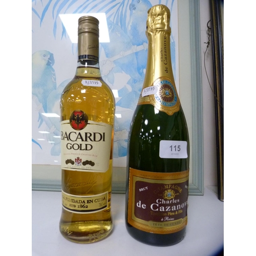 115 - Bottle of champagne and a bottle of Bacardi Gold.  (2)