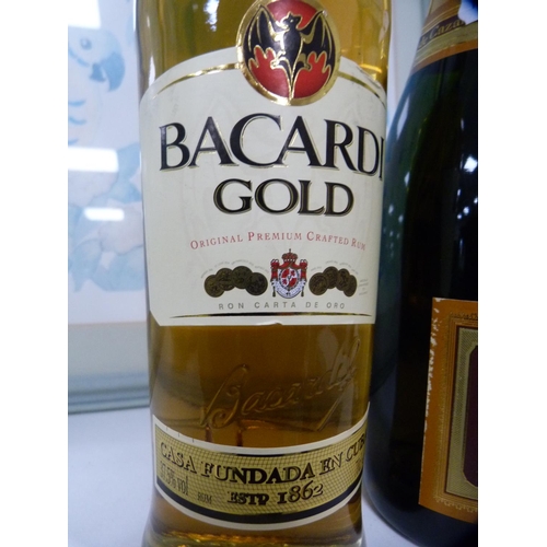 115 - Bottle of champagne and a bottle of Bacardi Gold.  (2)