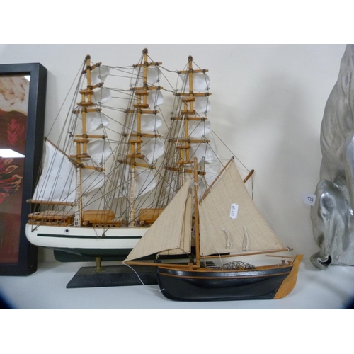 122 - Composite model of a seated greyhound and two model boats.