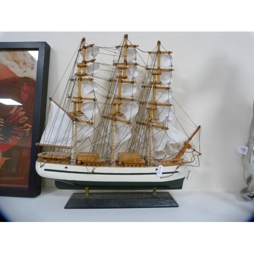 122 - Composite model of a seated greyhound and two model boats.