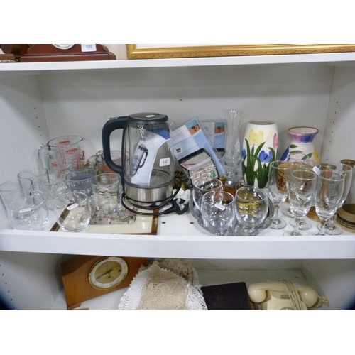 142 - Glass kettle, floral decorated vases, glassware etc (one shelf).