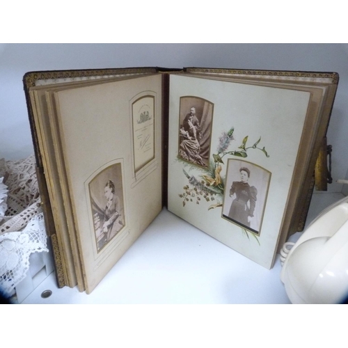 143 - Victorian photograph album, cream telephone, mantel clock and various table linen (one shelf).