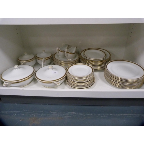 144 - Collection of Minton gilt decorated dinnerwares (one shelf).