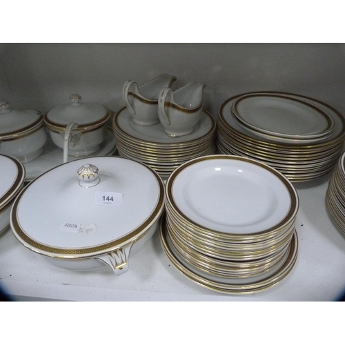 144 - Collection of Minton gilt decorated dinnerwares (one shelf).