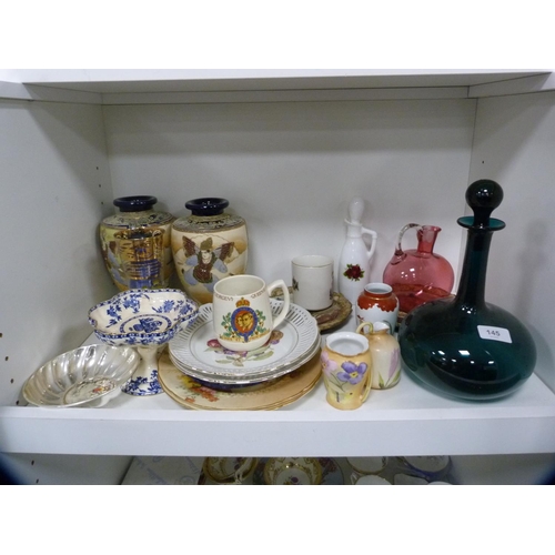 145 - Pair of Satsuma vases, green glass decanter, cranberry glass jug etc (one shelf).