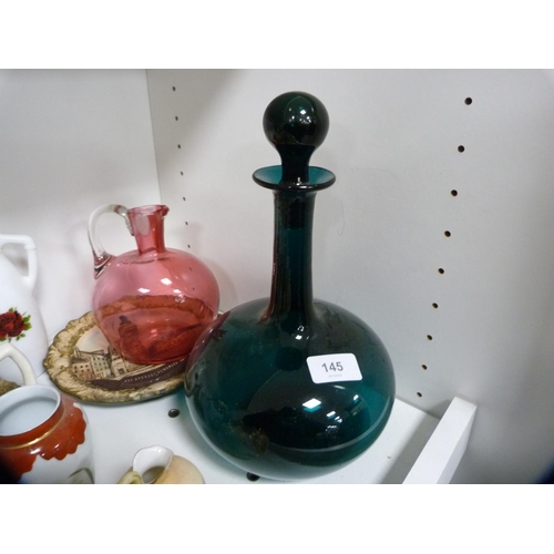 145 - Pair of Satsuma vases, green glass decanter, cranberry glass jug etc (one shelf).