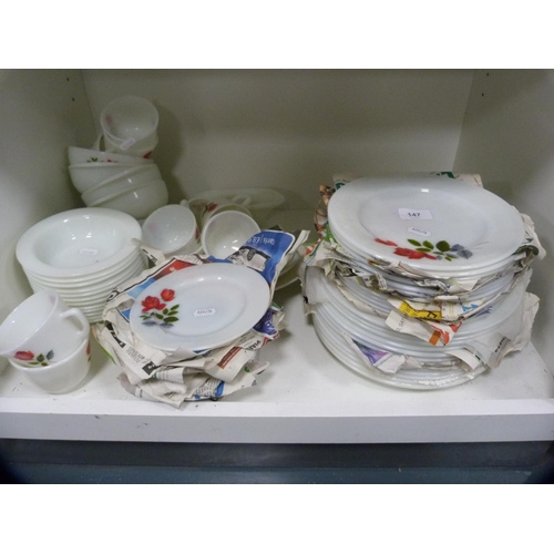 147 - Collection of floral decorated Pyrex dinnerwares (two shelves).