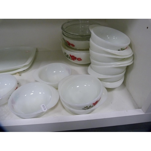 147 - Collection of floral decorated Pyrex dinnerwares (two shelves).