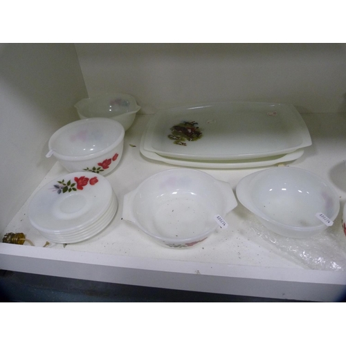 147 - Collection of floral decorated Pyrex dinnerwares (two shelves).