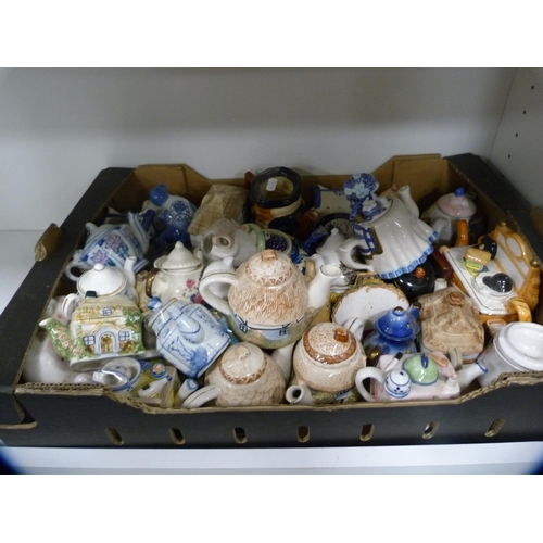 149 - Collection of novelty teapots and other decorative items (one shelf).