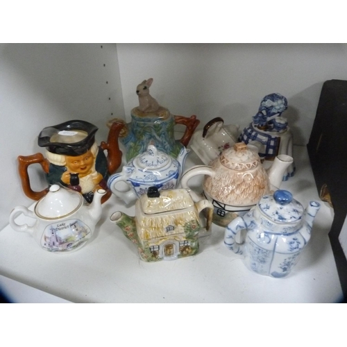 149 - Collection of novelty teapots and other decorative items (one shelf).