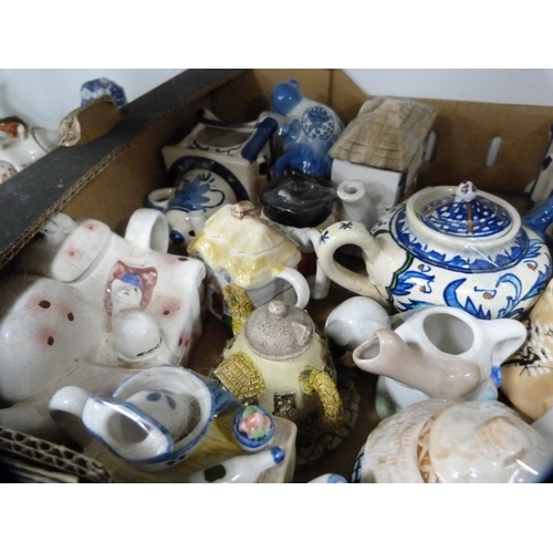 149 - Collection of novelty teapots and other decorative items (one shelf).