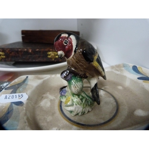 151 - Pair of turned wood candlesticks, hardstone goblets, Beswick goldfinch model etc (one shelf).