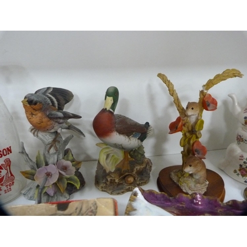 156 - Collection of cased glassware, decorative ceramics to include birds, perfumes etc (two shelves).