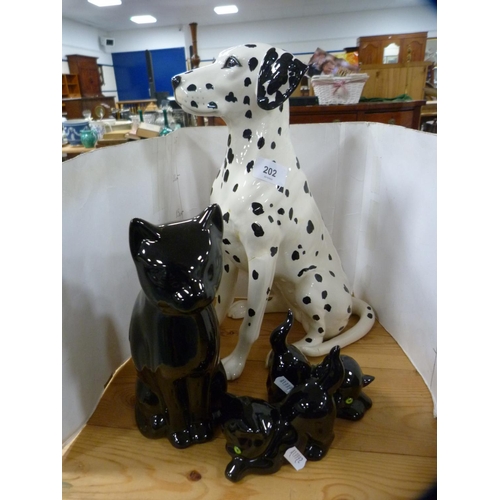 202 - Beswick model of a Dalmatian and three pottery cats.  (4)