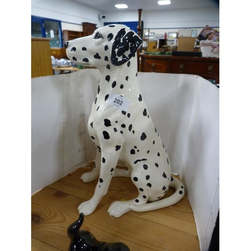 202 - Beswick model of a Dalmatian and three pottery cats.  (4)