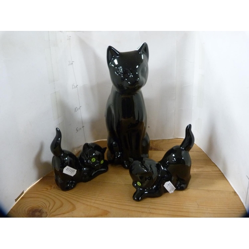 202 - Beswick model of a Dalmatian and three pottery cats.  (4)