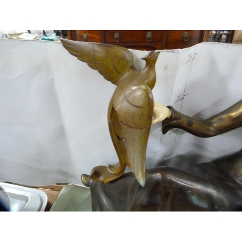 205 - Art Deco-style figure holding a bird, on plinth base.