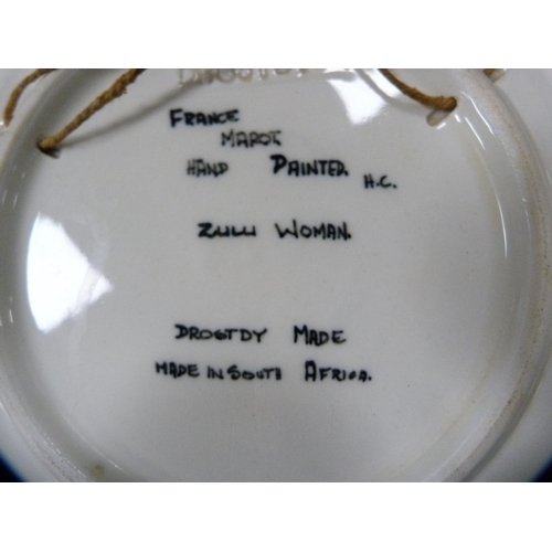 216 - Hand-decorated plate depicting a Zulu woman, a Jersey pottery bowl and an eastern bottle vase.