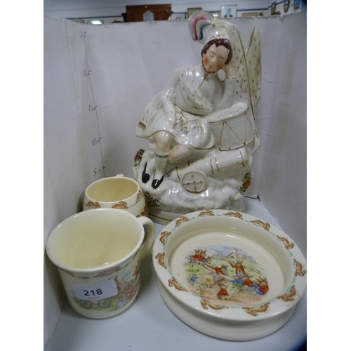 218 - Three pieces of Royal Doulton Bunnykins nursery ware and a Staffordshire flatback figure.  (4)