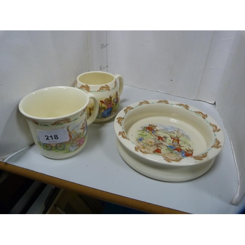 218 - Three pieces of Royal Doulton Bunnykins nursery ware and a Staffordshire flatback figure.  (4)