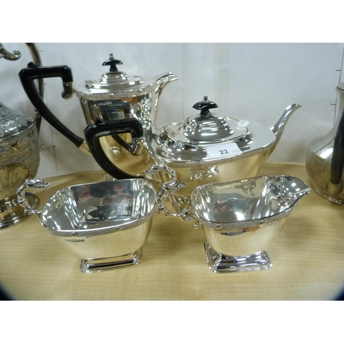 22 - EP four-piece tea set with ornate handles to the cream and sugar, and an EP water jug.  (5)