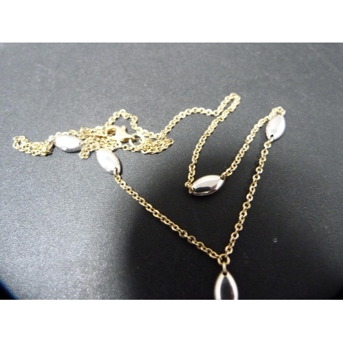 255 - 9ct yellow and white gold chain with pendant drop, 5.1g.