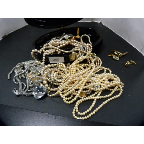 260 - Strings of faux pearls, costume cufflinks and costume pendants contained in a lacquered jewellery bo... 