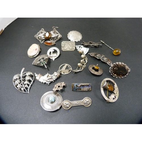 263 - Collection of silver and white metal badges and brooches to include a cameo brooch, clan brooch, Luc... 