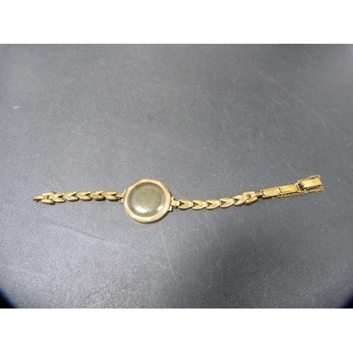 264 - 9ct gold-backed vintage lady's wristwatch.