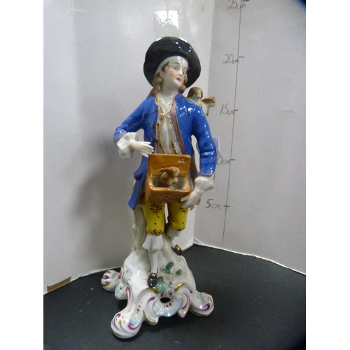 303 - Late 19th/early 20th century continental porcelain figure modelled as a wine seller, with crossed sw... 