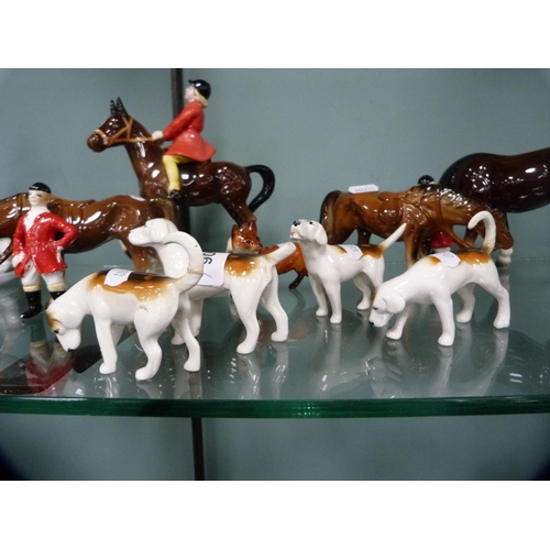 306 - Four Beswick hounds and a Beswick fox, together with other unmarked horses and riders.  (9)