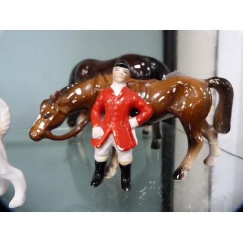 306 - Four Beswick hounds and a Beswick fox, together with other unmarked horses and riders.  (9)