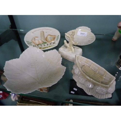 317 - Five pieces of Belleek porcelain to include a leaf-shaped dish, boat ornament, butter dish (black st... 